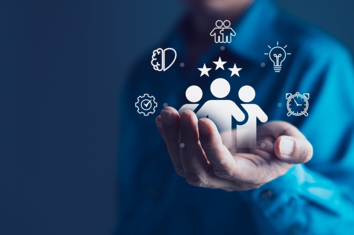 Businessman holding digital icons of a team with stars